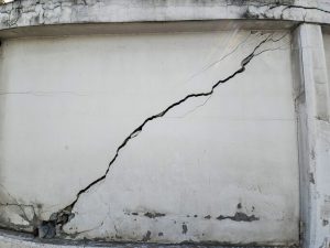Large cracked concrete wall resulting from an earthquake's impact