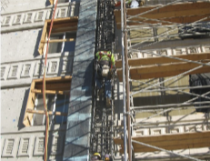 Ironworkers tying a cage beside an FRP- wrapped column