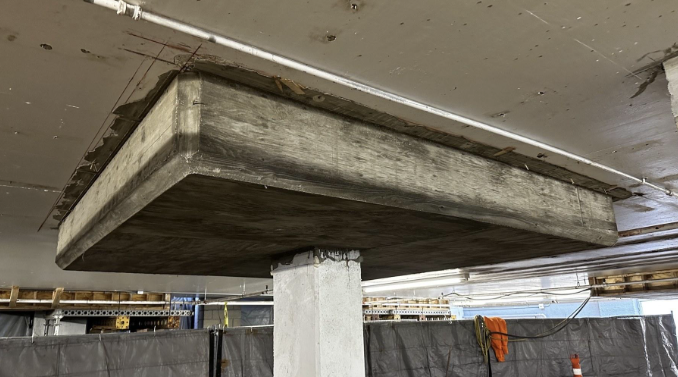 Slab-column strengthening of an operating parking structure
